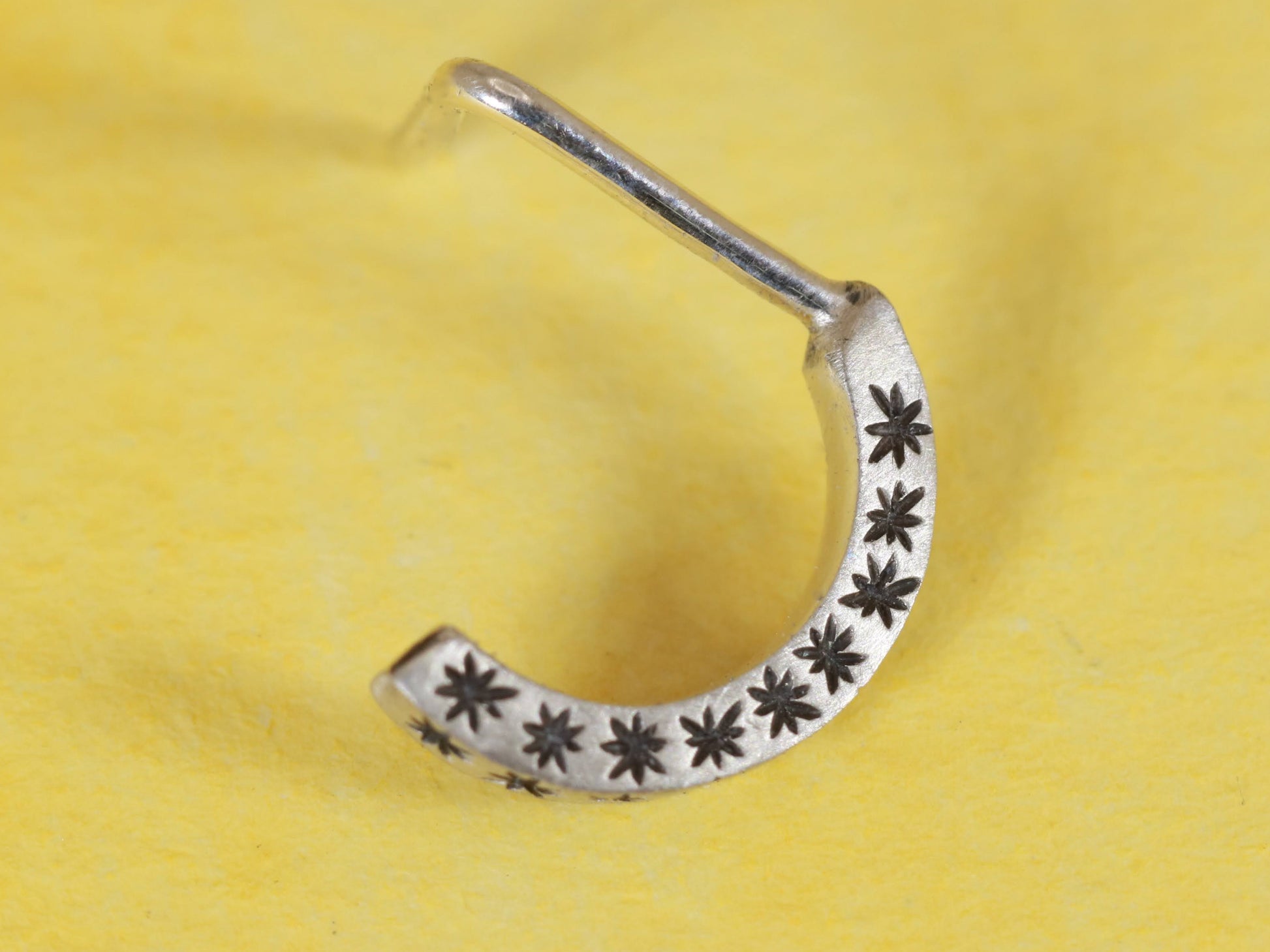 14k gold or sterling silver nose huggie hoop stud illusion hoop nostril jewelry with hand carved stars. Completely handmade by a small business.