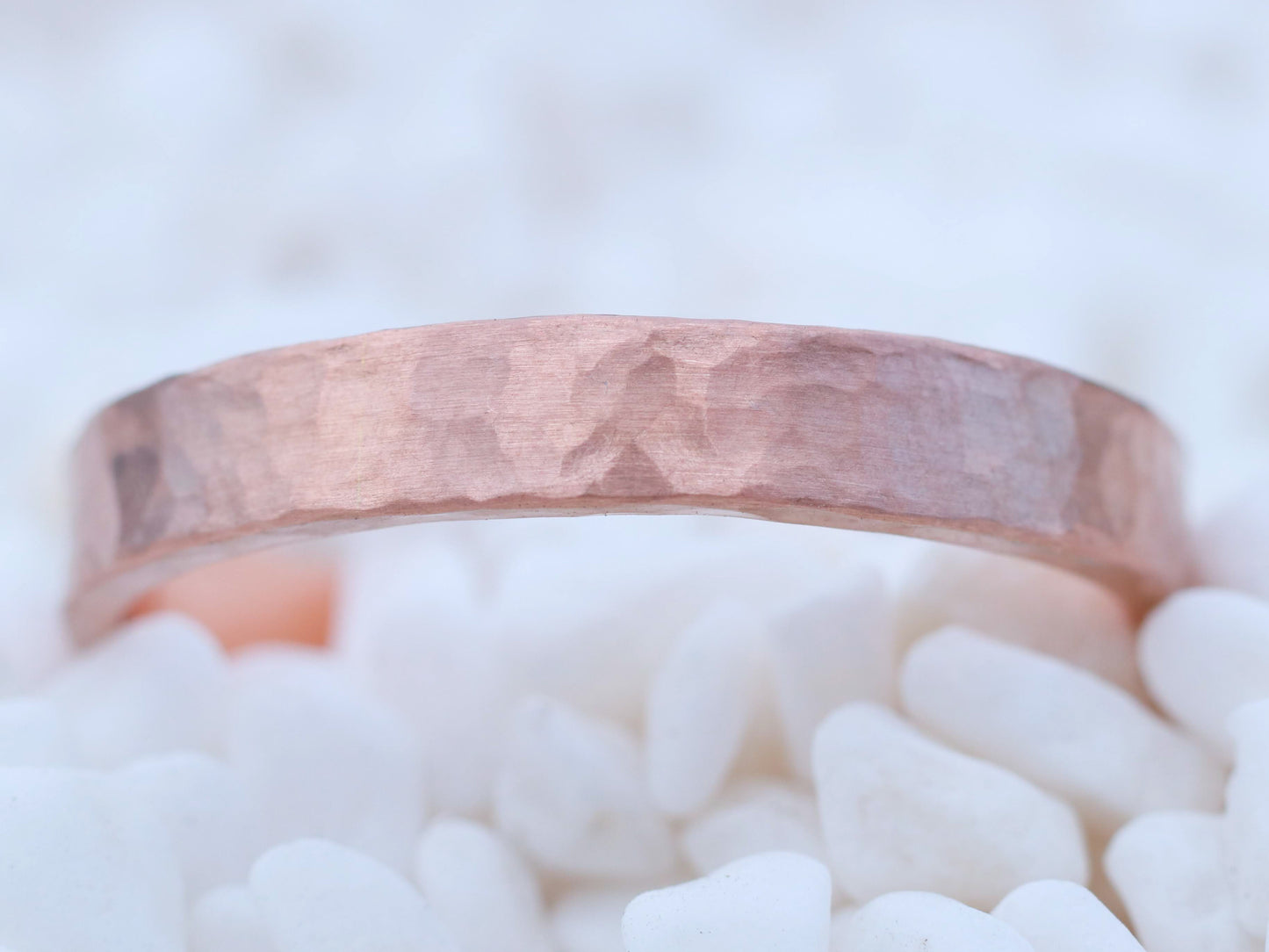 Solid 14k gold ring band measuring 4mm wide, textured with a hammer and finished with a matte surface.