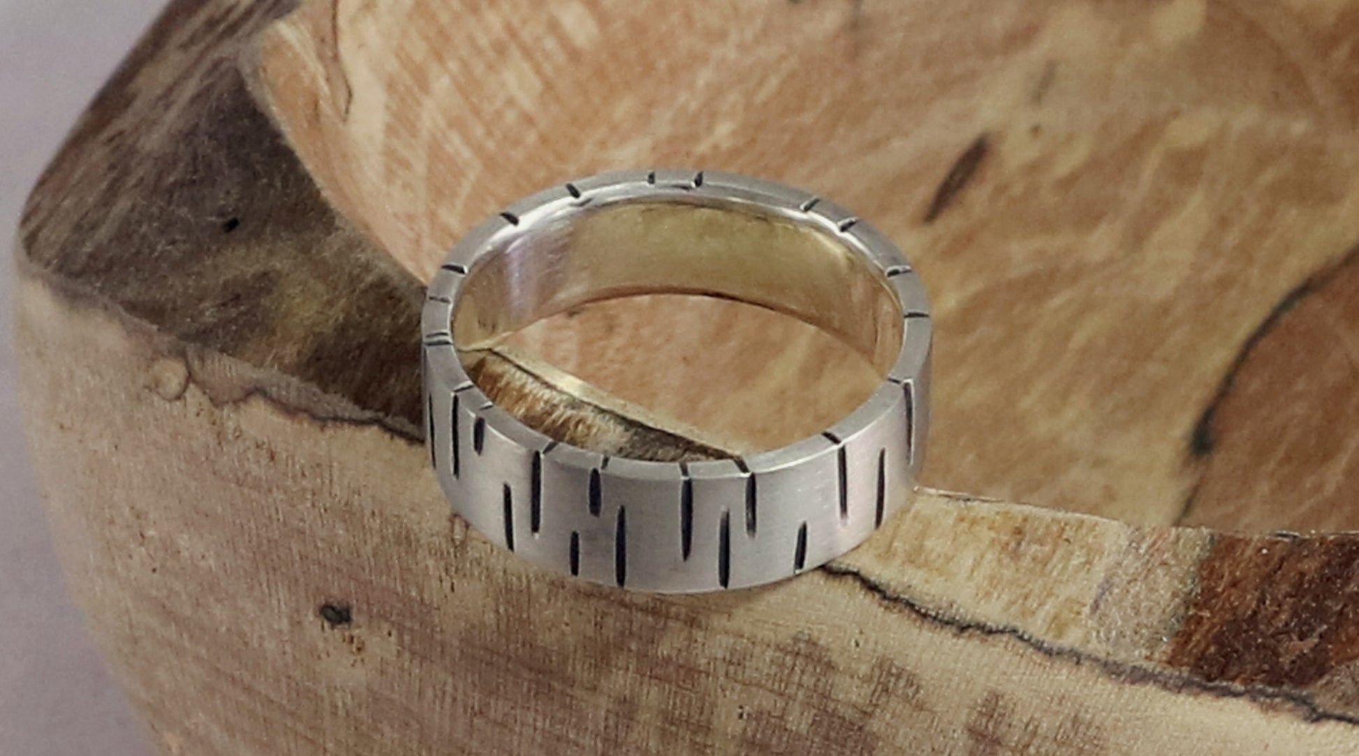 6mm sterling silver ring band with offset, randomly spaced, black lines.