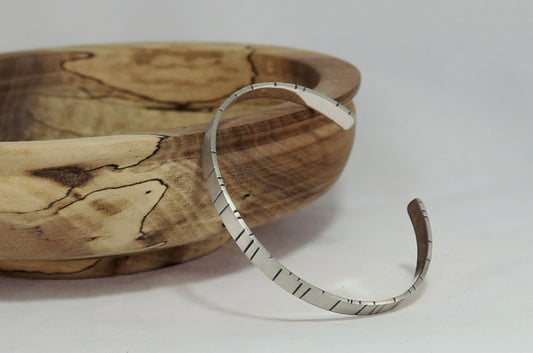 6mm sterling silver cuff with randomly spaced black lines.