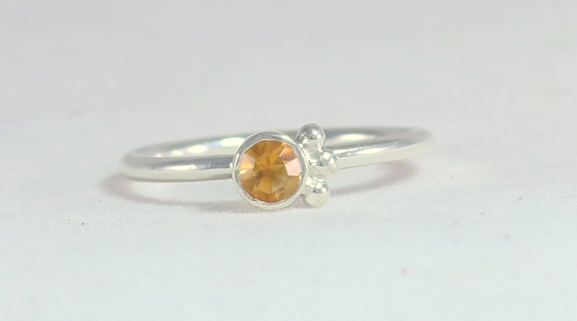 Natural gemstone set in sterling silver bezel, 3 silver bubble accents along bezel on sterling silver ring band.