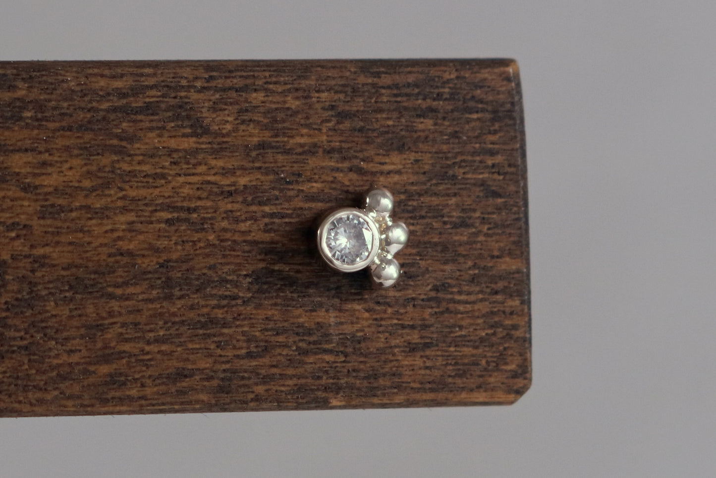Studs with 3mm white diamonds set in 14k white gold with 3 bubbles in a group at the bottom.