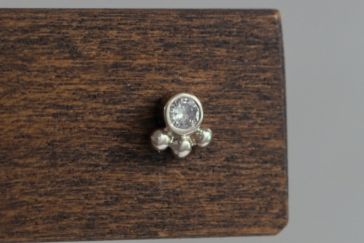 Studs with 3mm white diamonds set in 14k white gold with 3 bubbles in a group at the bottom.