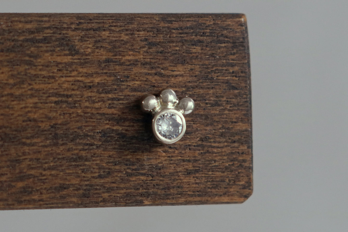 Studs with 3mm white diamonds set in 14k white gold with 3 bubbles in a group at the bottom.