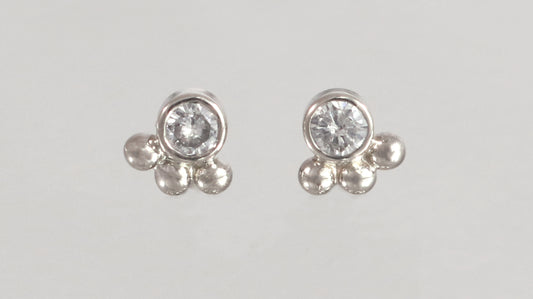 Studs with 3mm white diamonds set in 14k white gold with 3 bubbles in a group at the bottom.