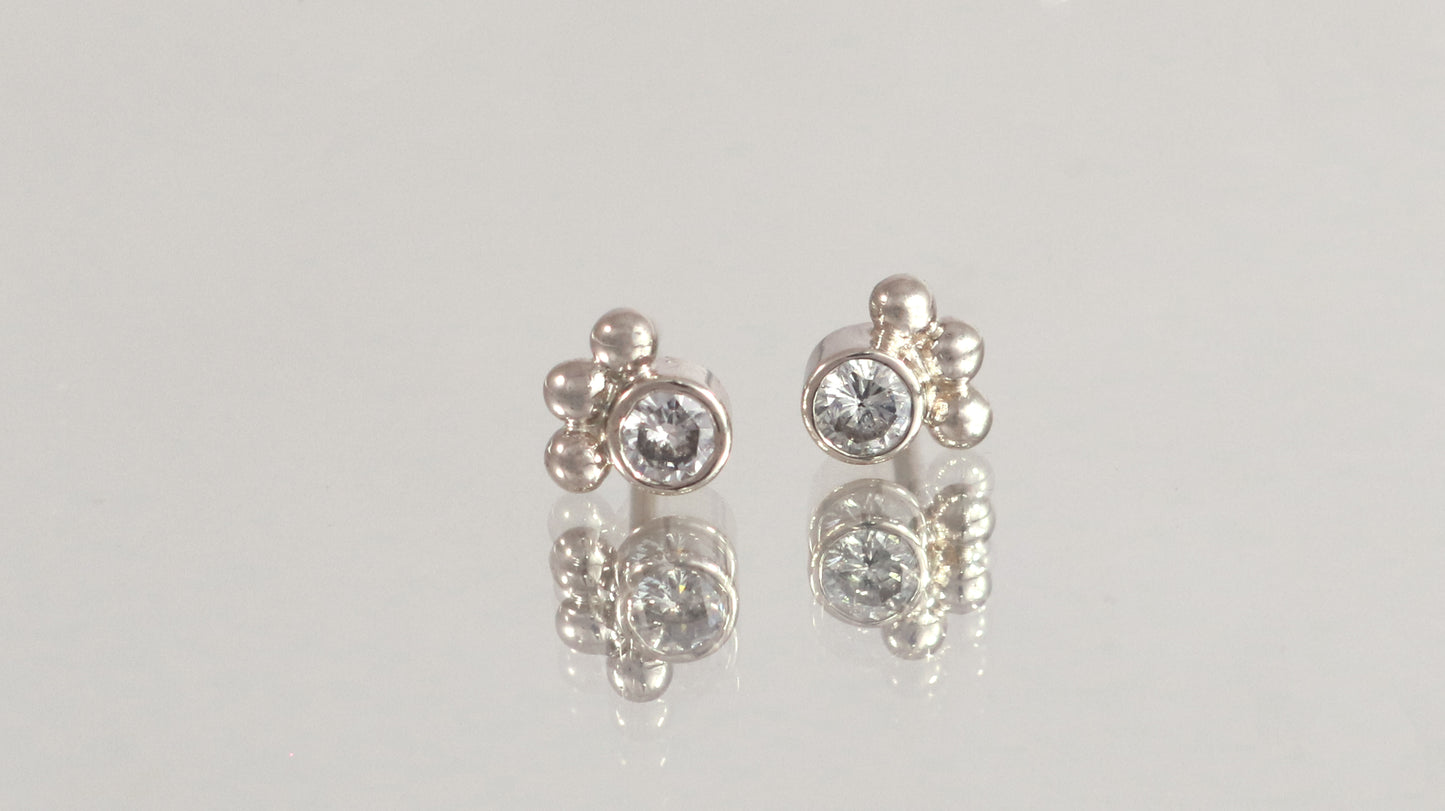 Studs with 3mm white diamonds set in 14k white gold with 3 bubbles in a group at the bottom.