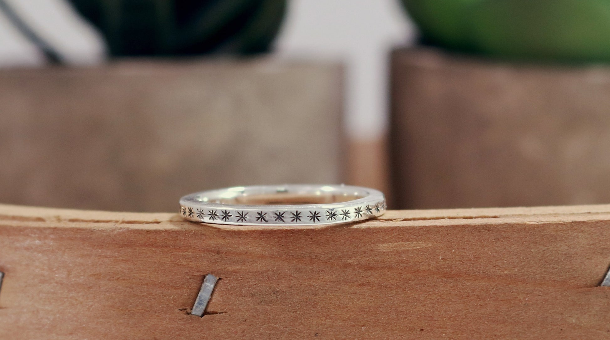 2mm squared ring band with black hand carved stars around the entire band.