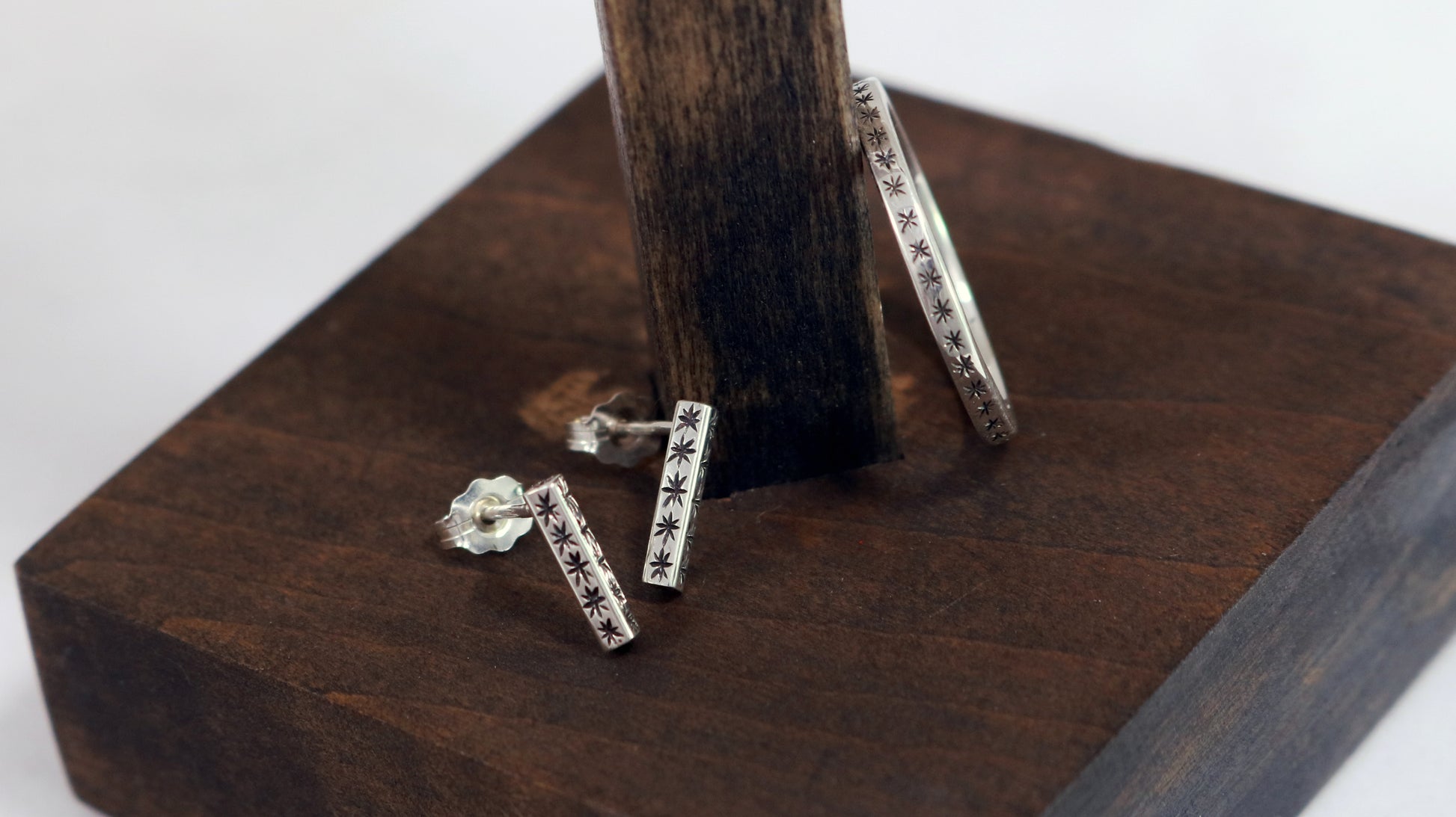 2mm squared ring band with black hand carved stars around the entire band & silver star bar studs from the same collection.