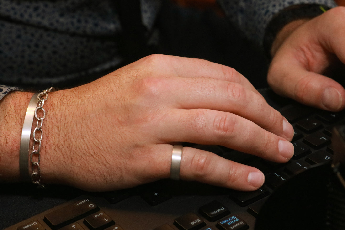 A model wearing a 6mm sterling silver cuff with a matte finish outside & polished inside.