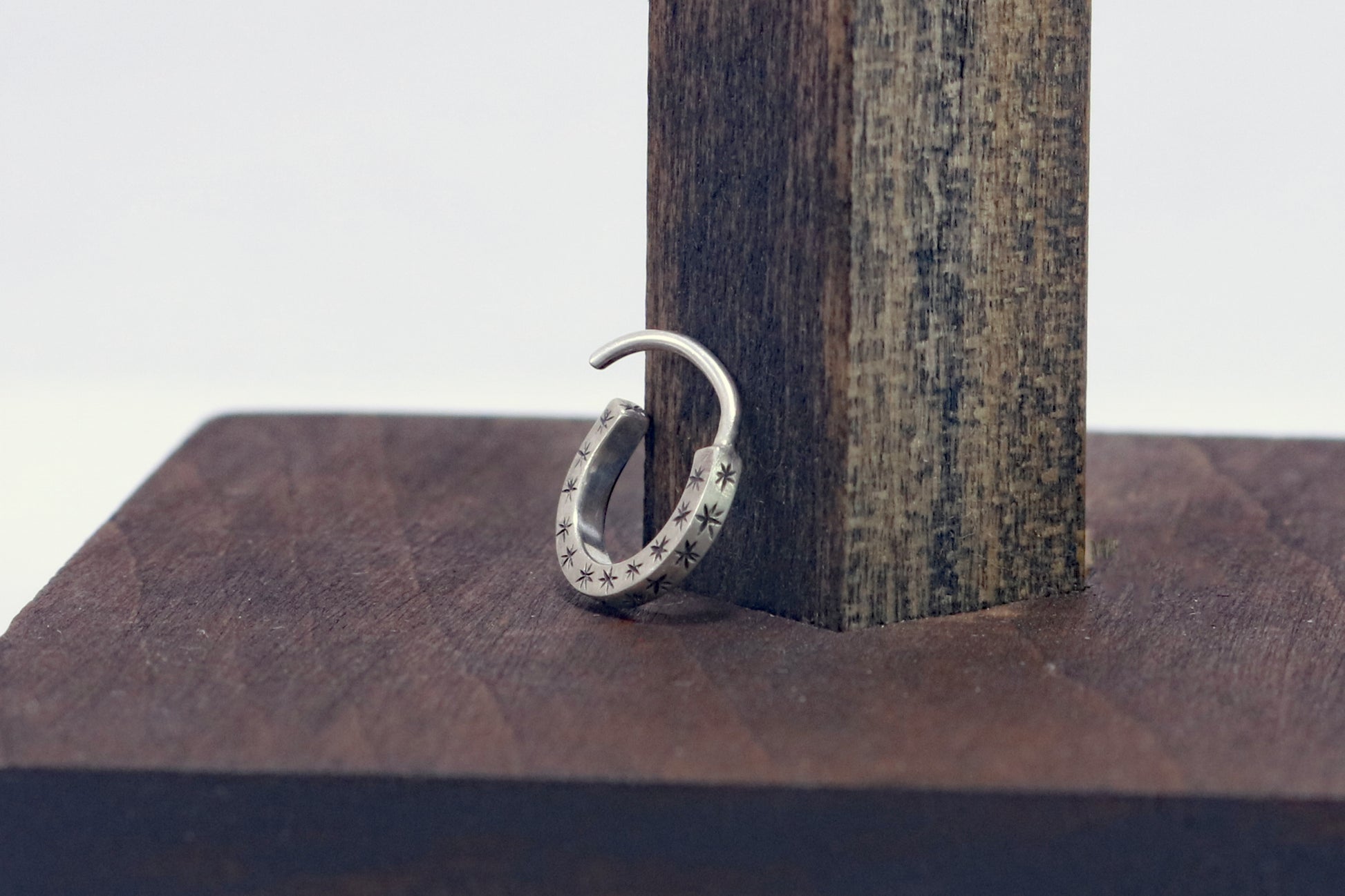 Hoops made from 1.5mm x 1.5mm square sterling silver, hand cut black stars on all outward facing sides.