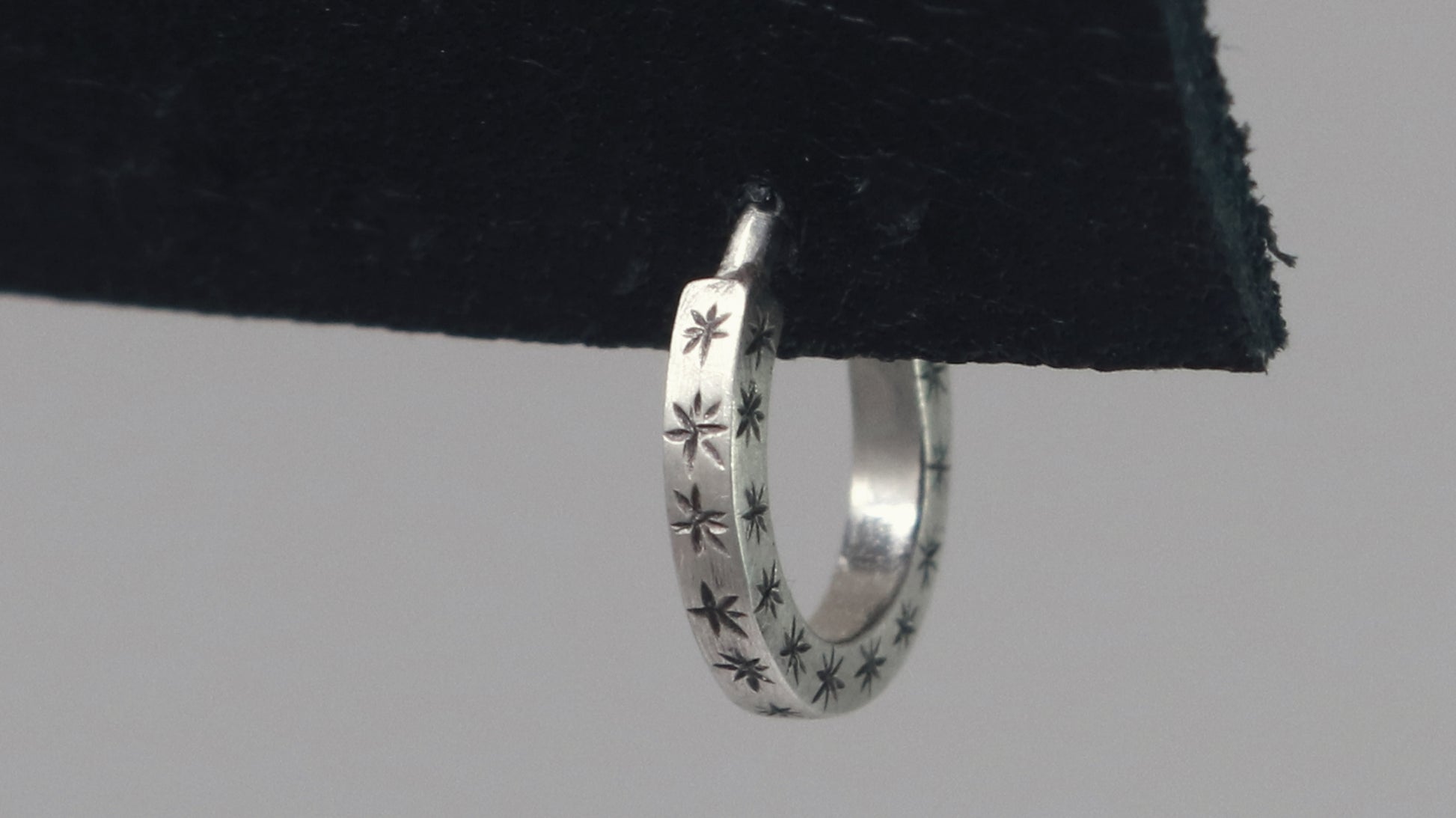 Hoops made from 1.5mm x 1.5mm square sterling silver, hand cut black stars on all outward facing sides.