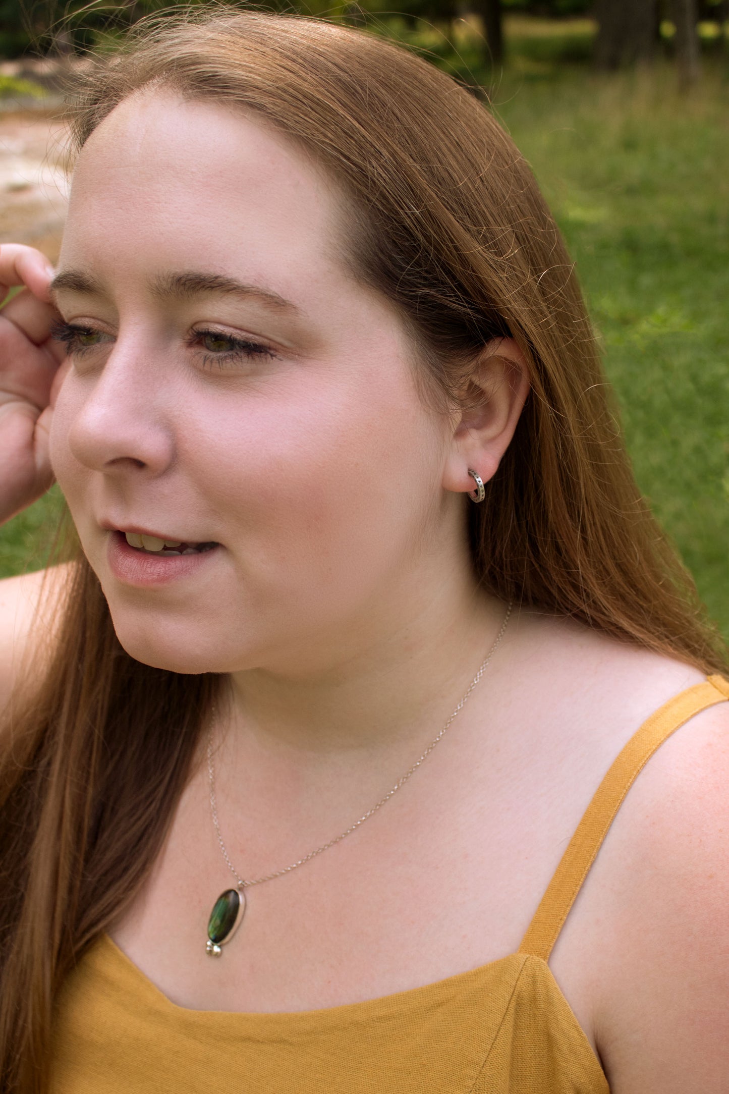 2mm sterling silver hoop huggie earrings with hand cut black stars.