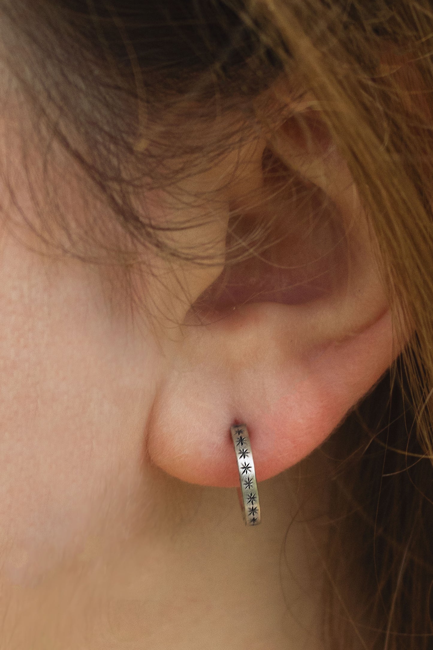 2mm sterling silver hoop huggie earrings with hand cut black stars.