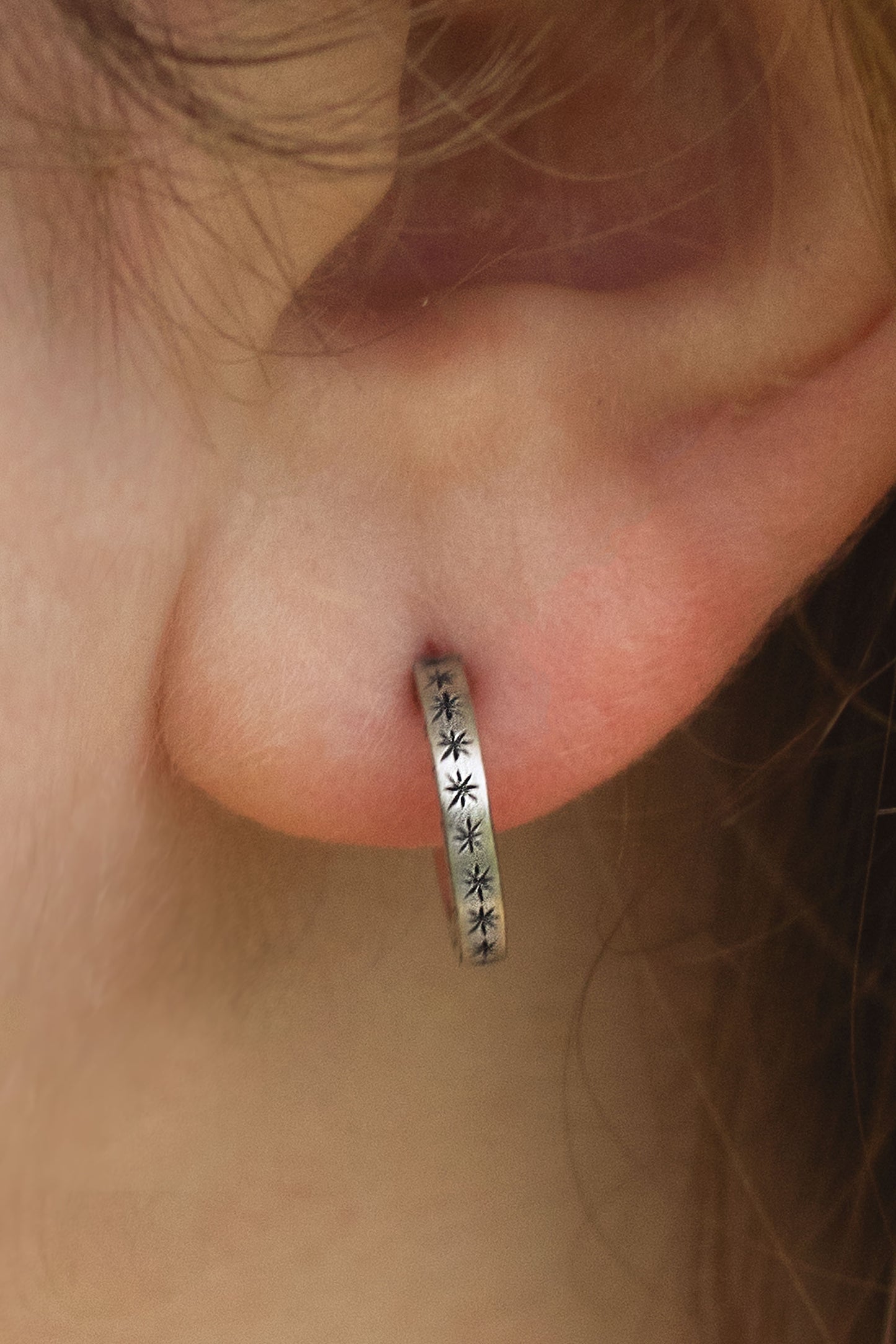 2mm sterling silver hoop huggie earrings with hand cut black stars.