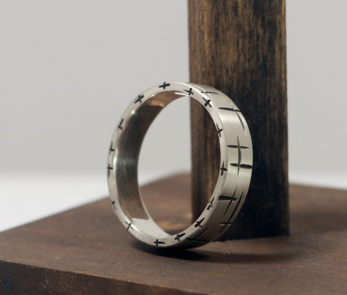 Black cross hatch marks all around this 6mm sterling silver ring band.