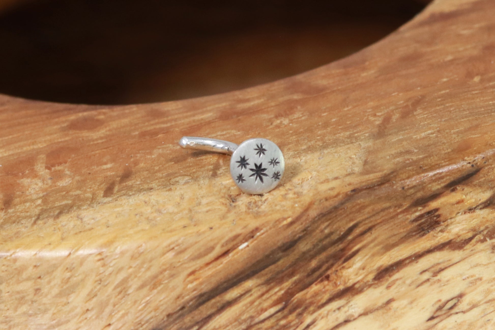 5mm, flat, solid sterling silver disc nose stud with black hand carved stars.