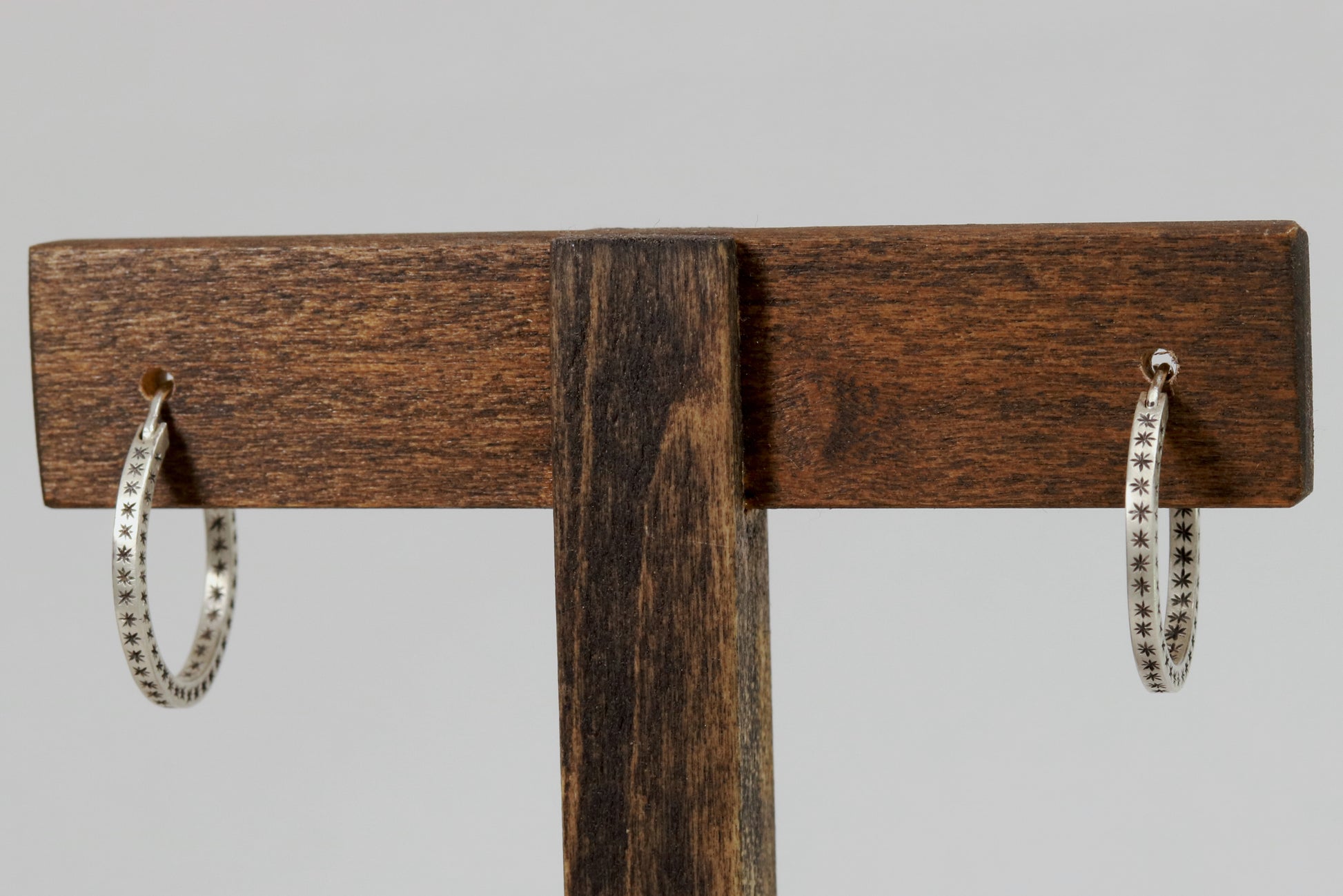 Closing hoops made from 2mm x 2mm square sterling silver, hand cut black stars on all sides.