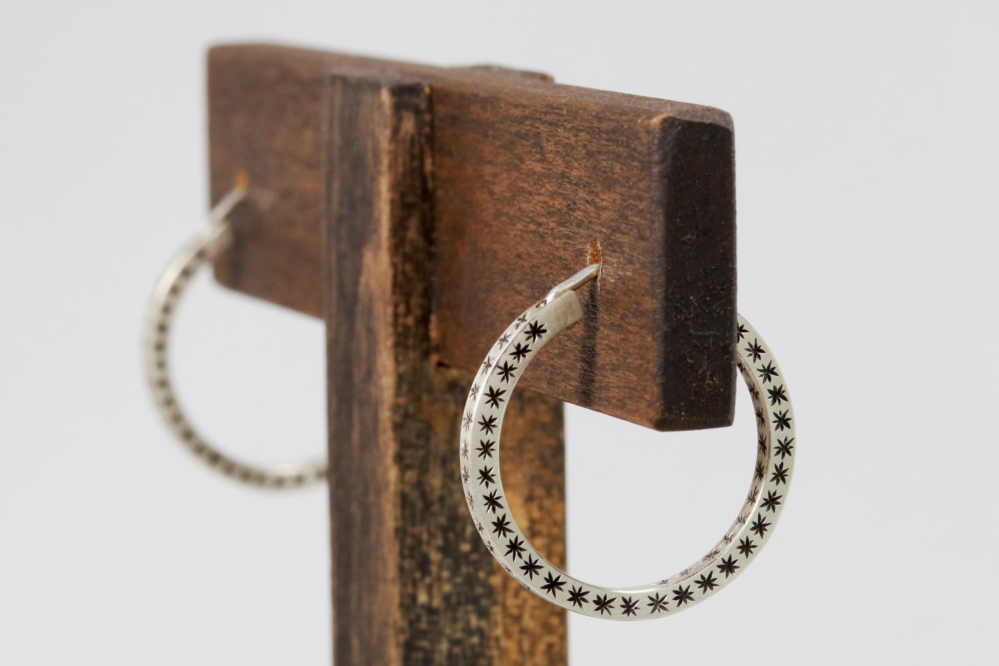 Closing hoops made from 2mm x 2mm square sterling silver, hand cut black stars on all sides.