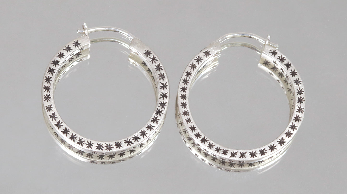 Closing hoops made from 2mm x 2mm square sterling silver, hand cut black stars on all sides.
