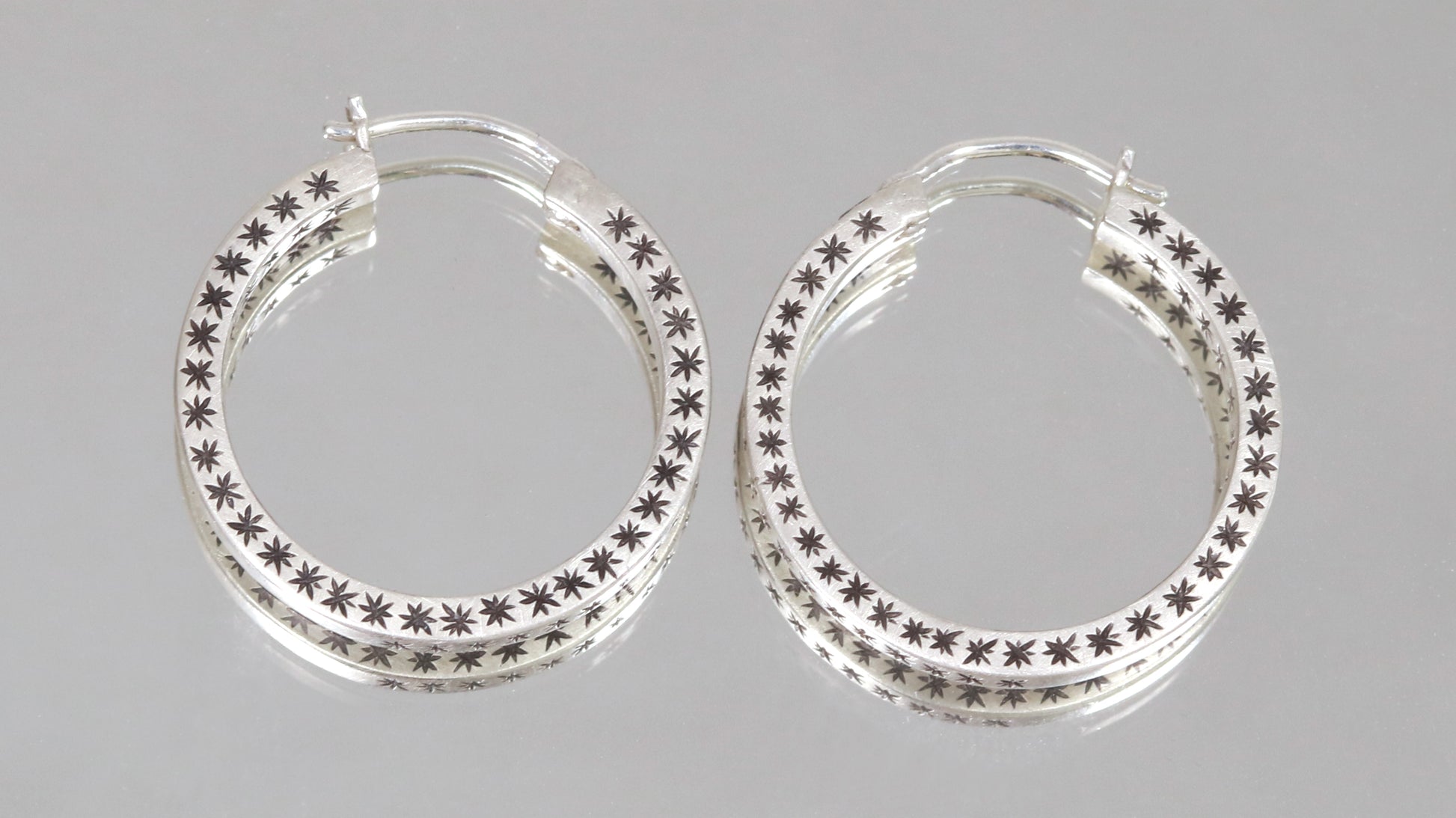 Closing hoops made from 2mm x 2mm square sterling silver, hand cut black stars on all sides.