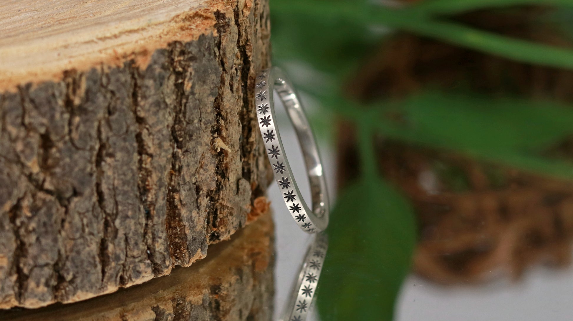 2mm squared ring band with black hand carved stars around the entire band.