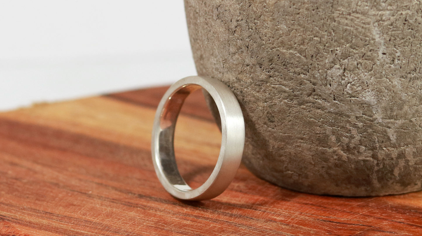 A sterling silver ring band with a matte finish outside & polished finish inside, 4mm wide, 1.7mm thick.