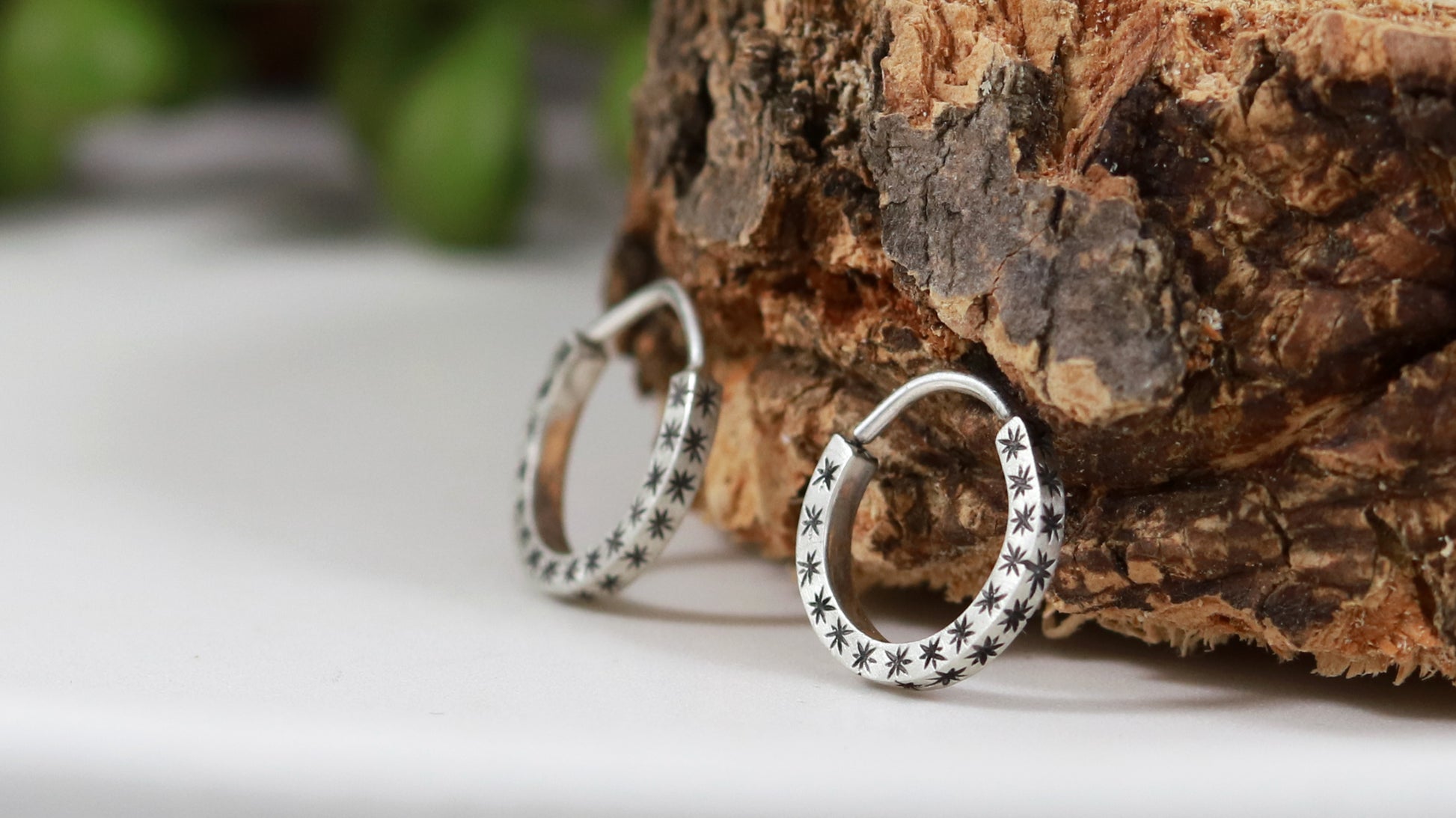 Hoops made from 1.5mm x 1.5mm square sterling silver, hand cut black stars on all outward facing sides.