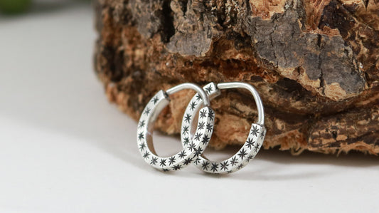 Hoops made from 1.5mm x 1.5mm square sterling silver, hand cut black stars on all outward facing sides.