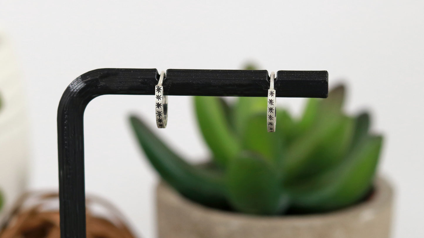 Hoops made from 1.5mm x 1.5mm square sterling silver, hand cut black stars on all outward facing sides.