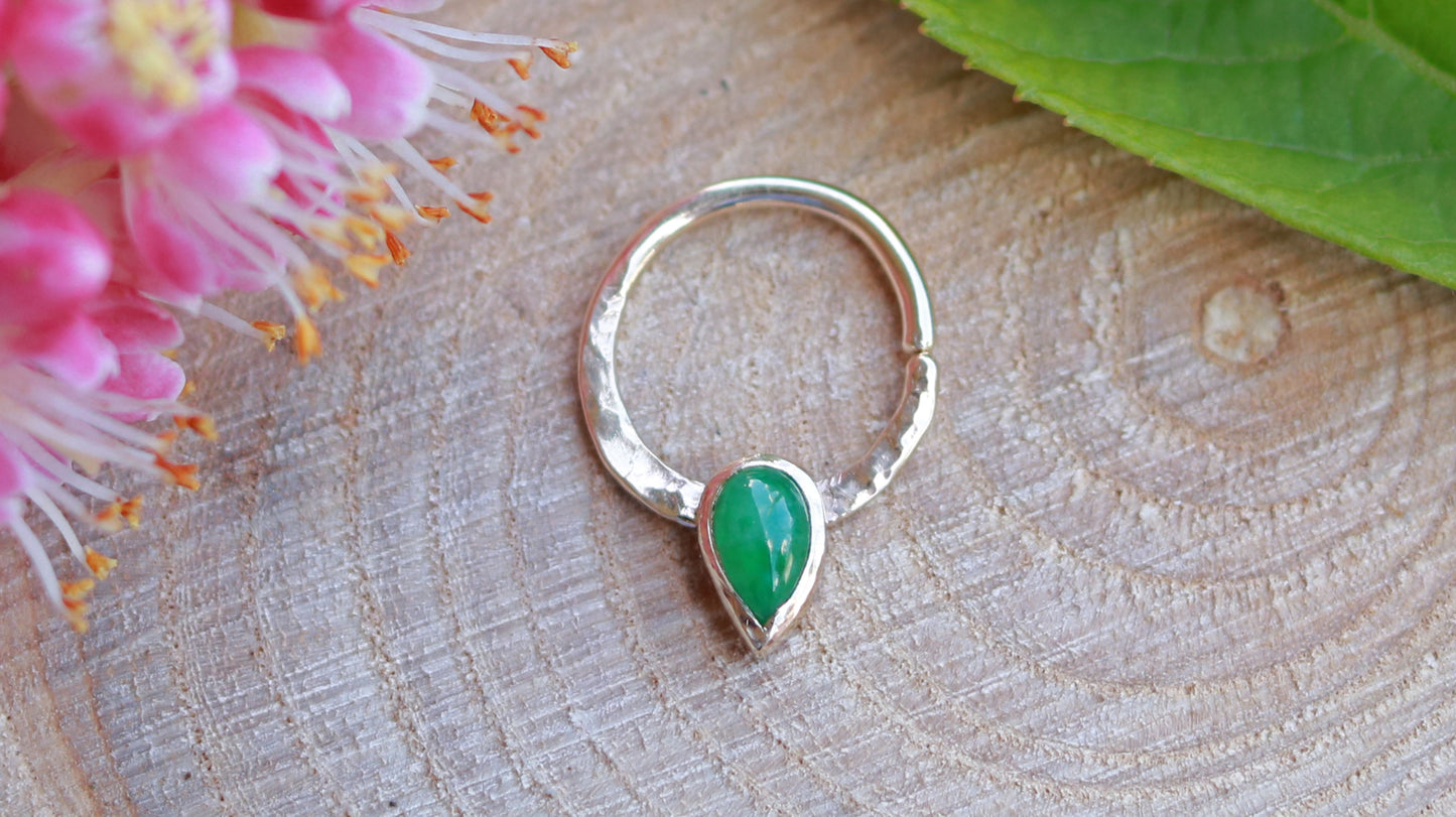 14k yellow gold septum hoop with an upside down pear gemstone at the bottom.