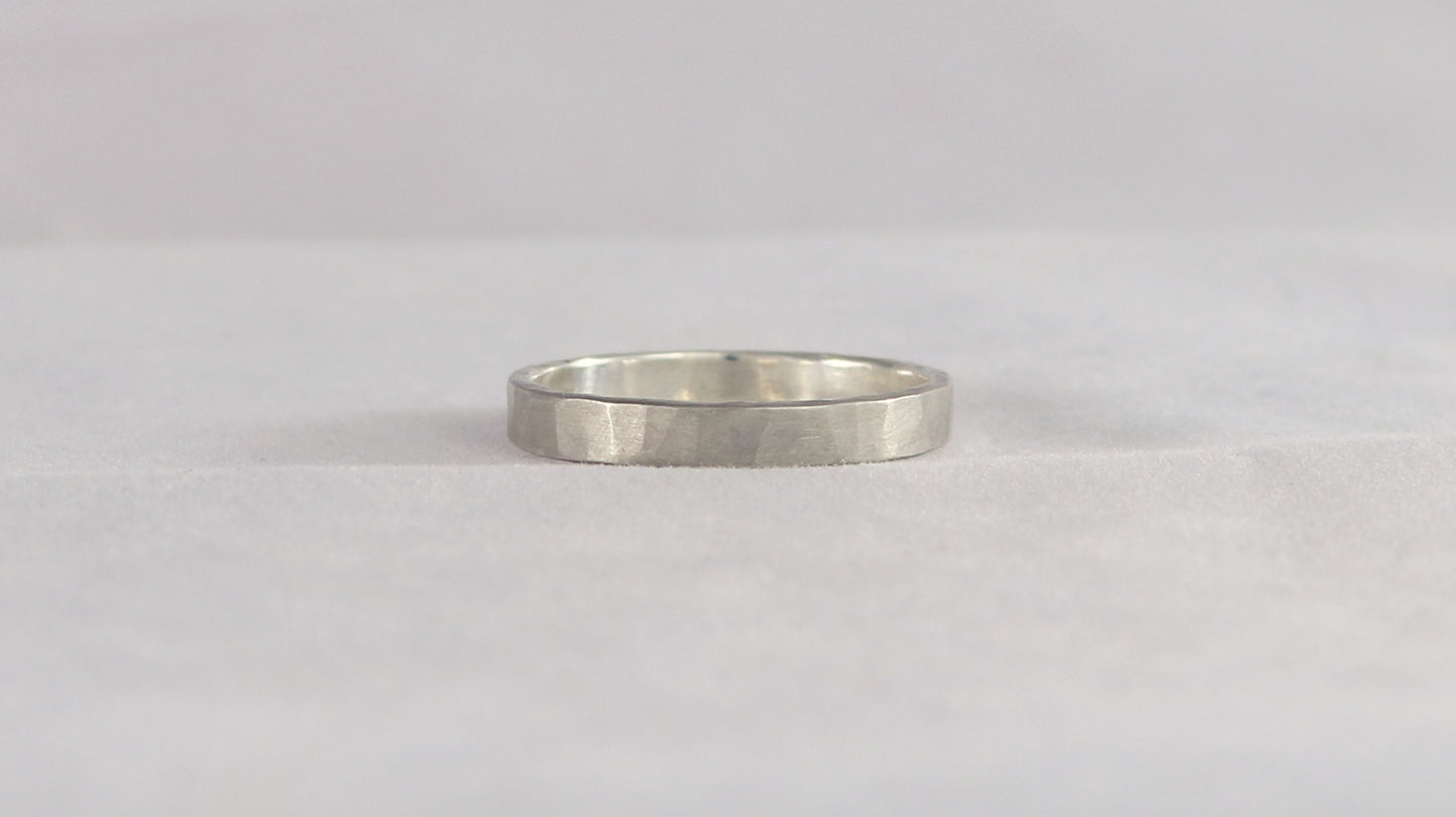 A 4mm silver ring band with a soft hammer texture.
