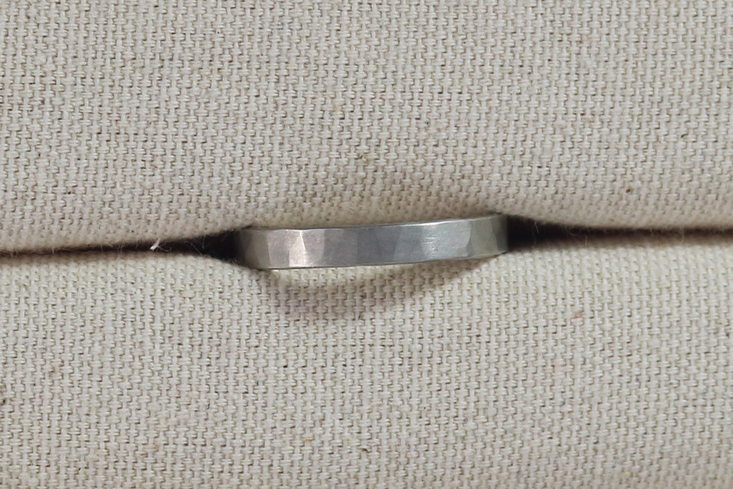 A 4mm silver ring band with a soft hammer texture.