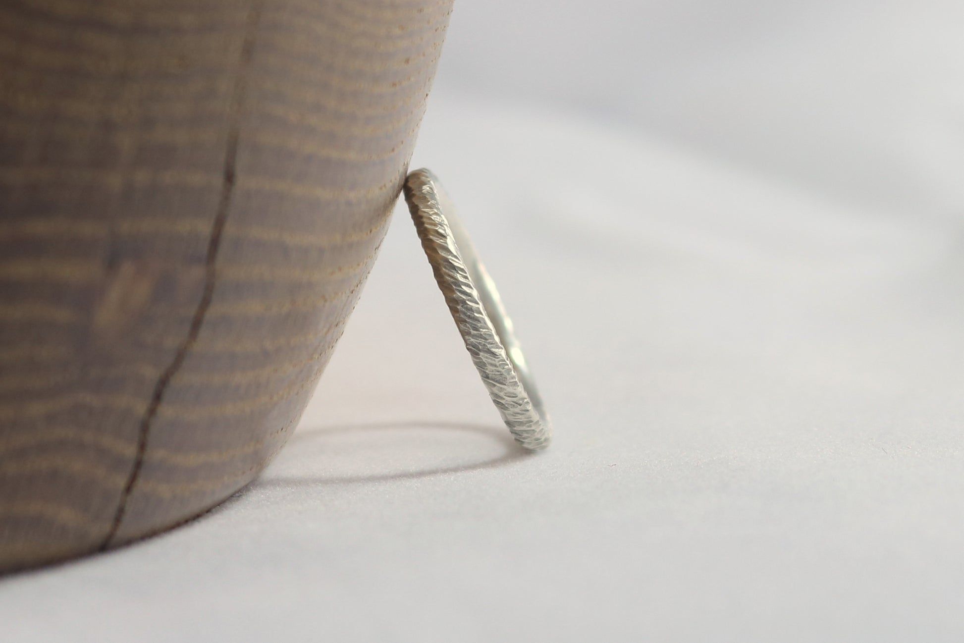 A thick sterling silver ring band with a rough hammer texture.