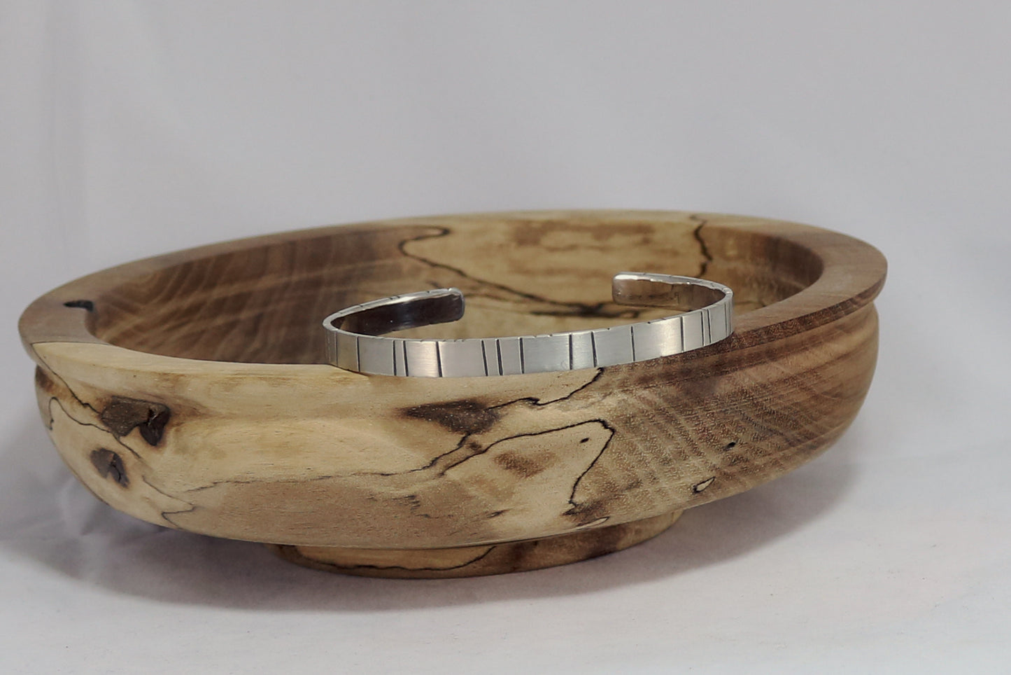 6mm sterling silver cuff with randomly spaced black lines.