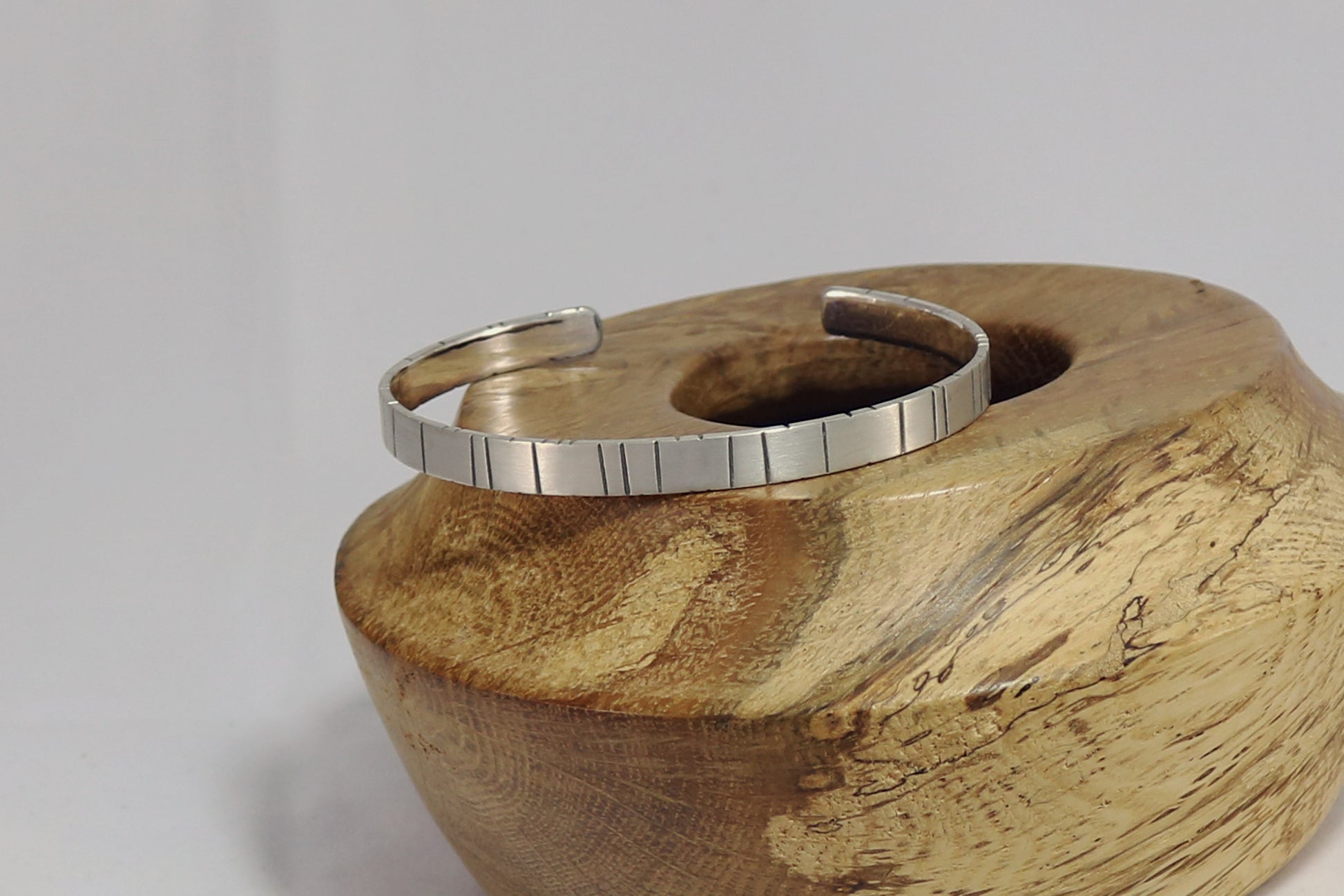 6mm sterling silver cuff with randomly spaced black lines.