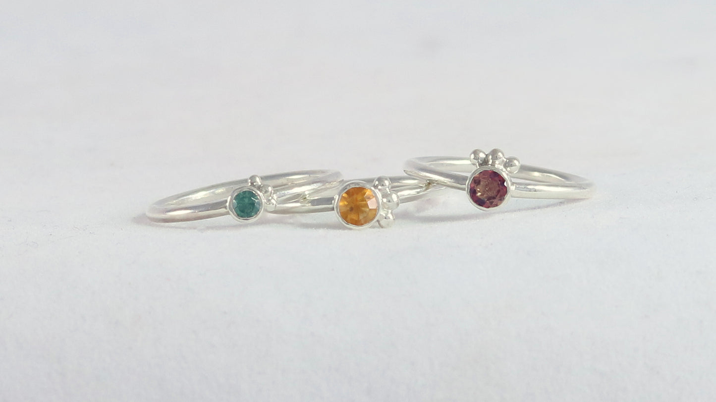 Natural gemstone set in sterling silver bezel, 3 silver bubble accents along bezel on sterling silver ring band.