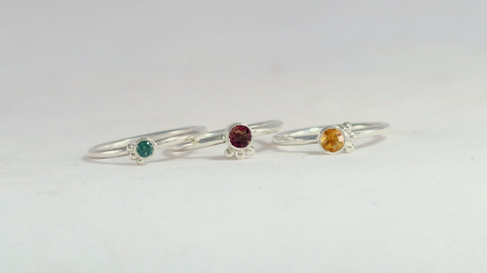 Natural gemstone set in sterling silver bezel, 3 silver bubble accents along bezel on sterling silver ring band.