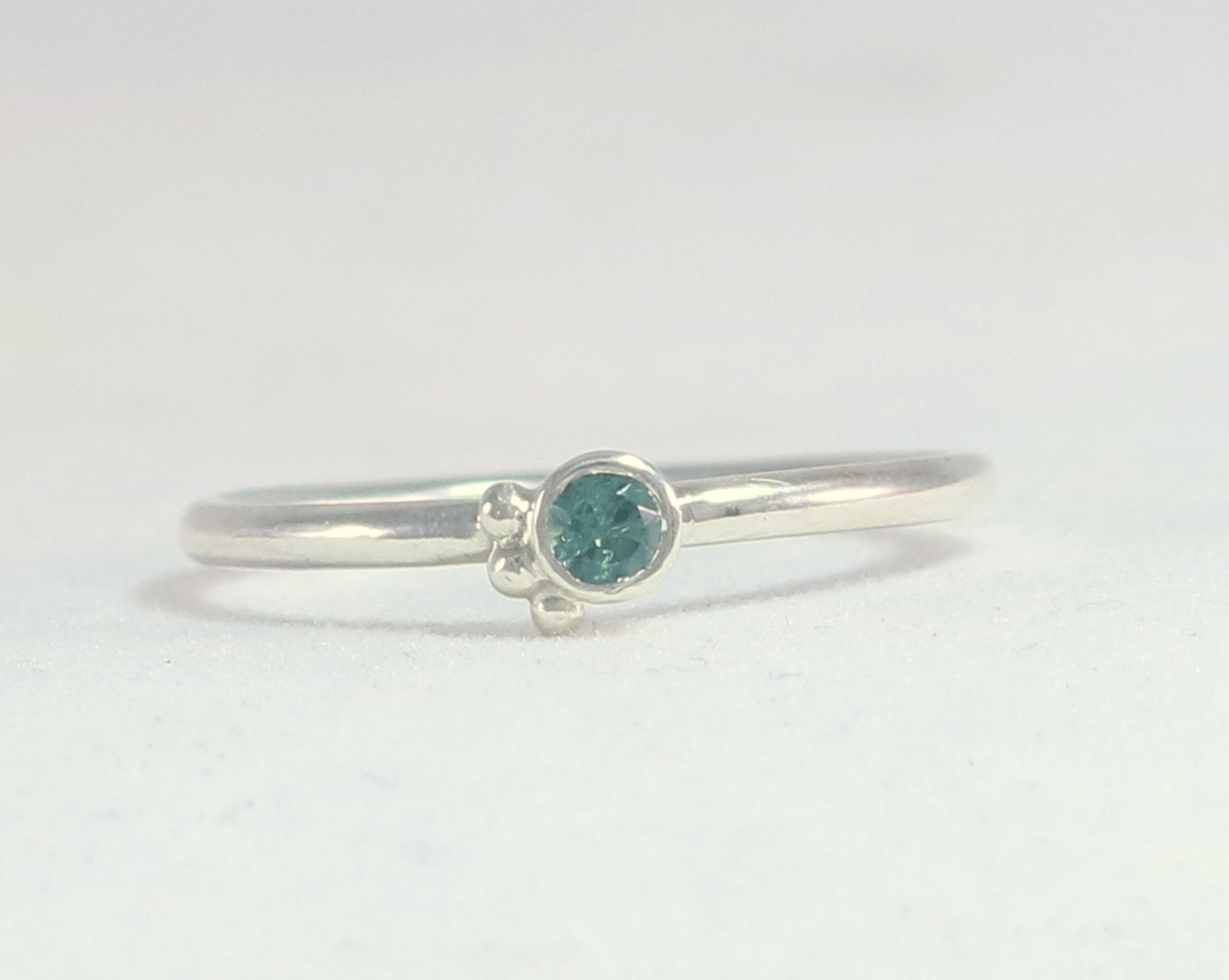 Natural gemstone set in sterling silver bezel, 3 silver bubble accents along bezel on sterling silver ring band.