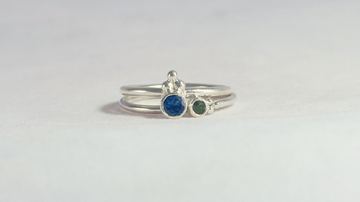 Natural gemstone set in sterling silver bezel on a sterling silver ring band with 3 silver bubbles in a pyramid.