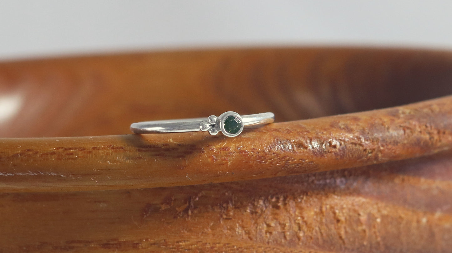 Natural gemstone set in sterling silver bezel on a sterling silver ring band with 3 silver bubbles in a pyramid.