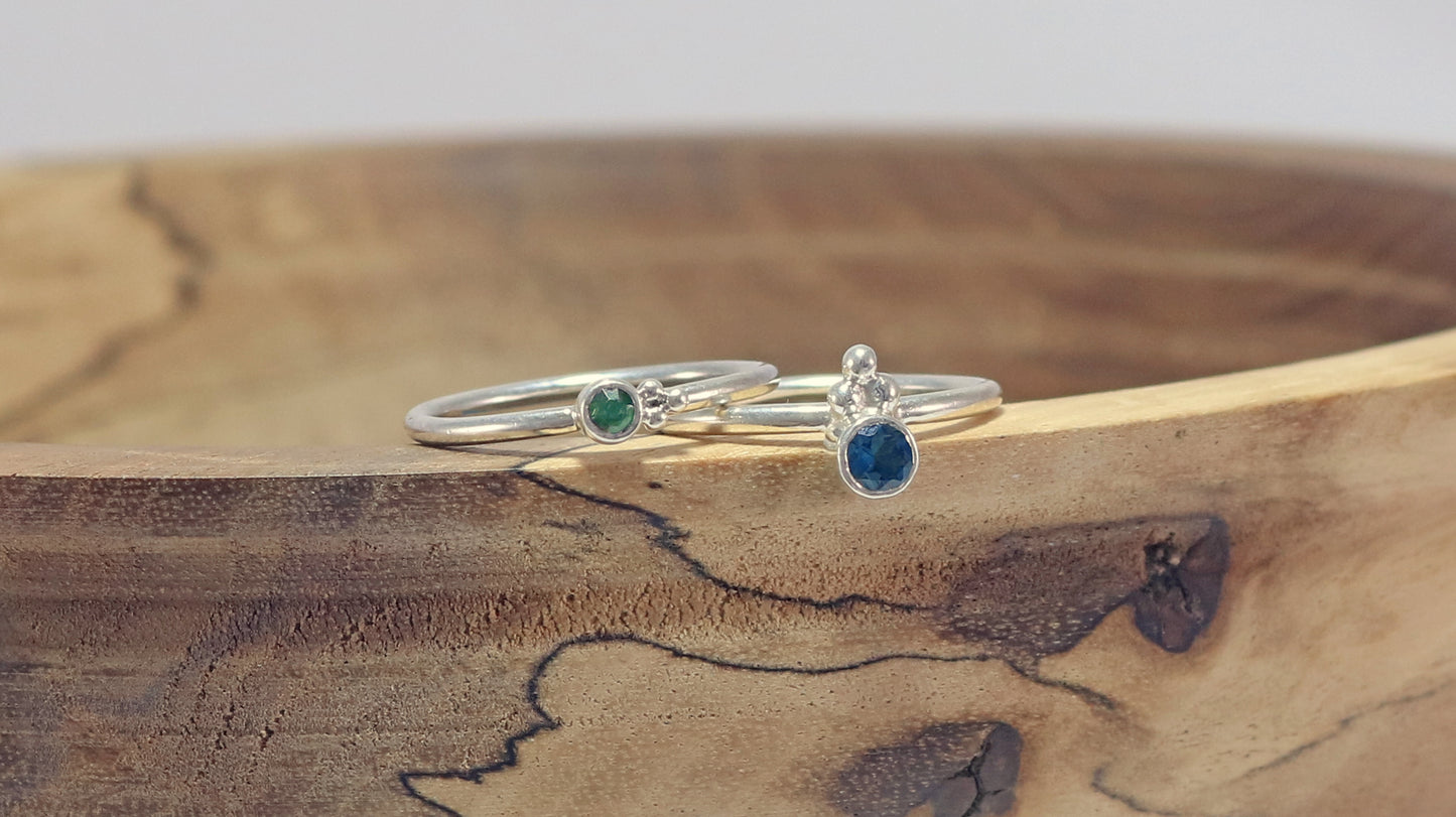 Natural gemstone set in sterling silver bezel on a sterling silver ring band with 3 silver bubbles in a pyramid.
