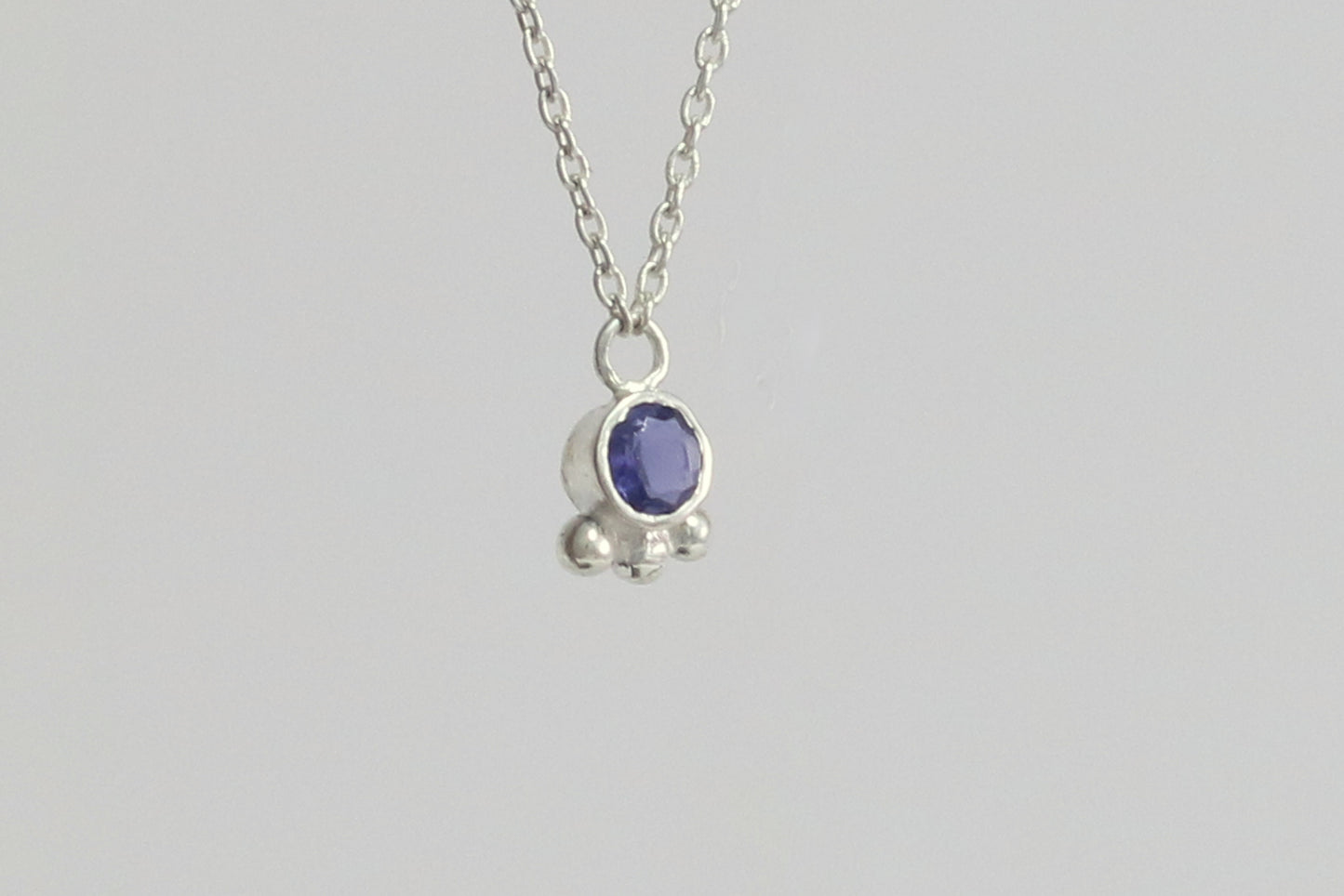 Natural gemstone set in sterling silver bezel with 3 silver bubble accents on a sterling silver chain.