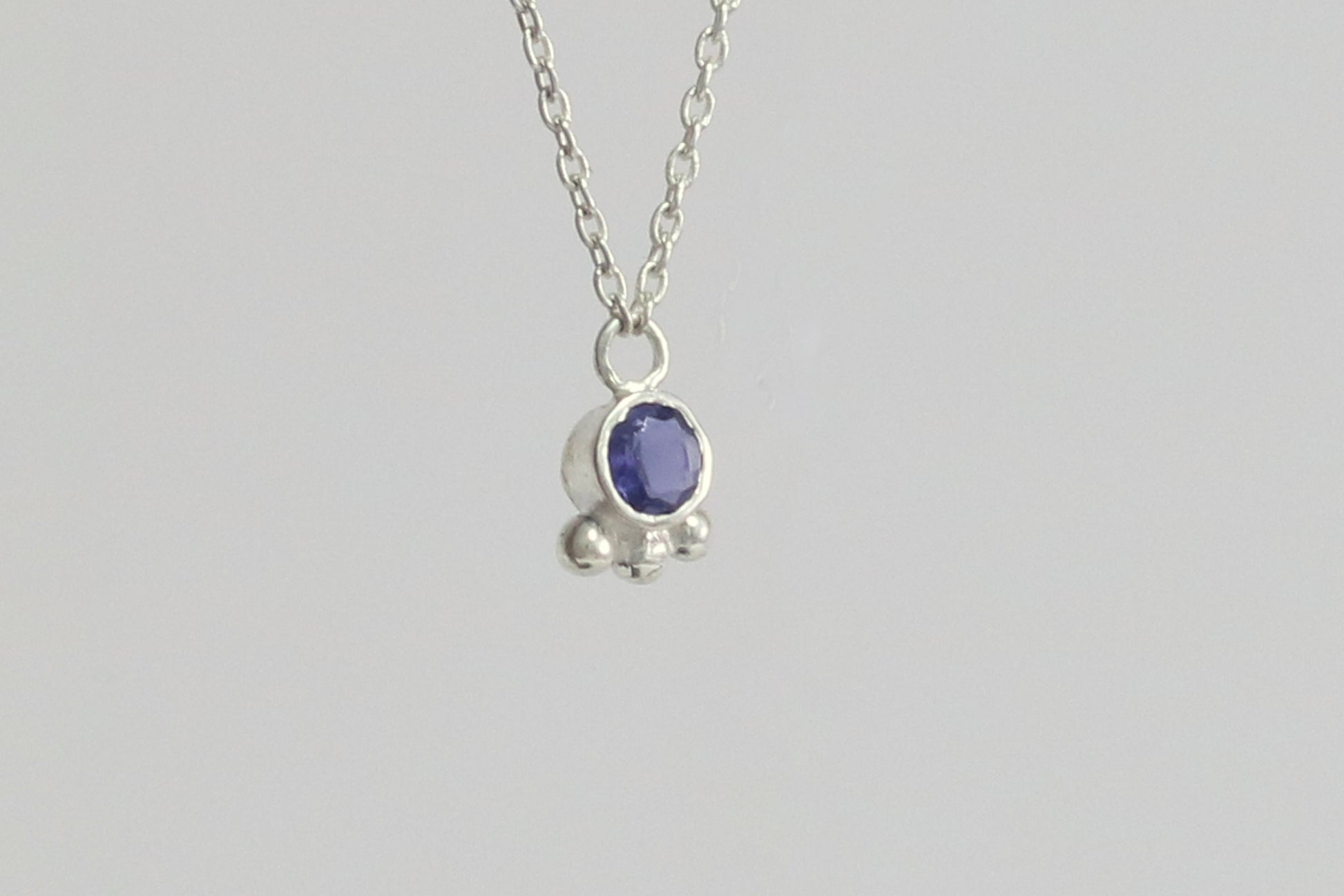 Natural gemstone set in sterling silver bezel with 3 silver bubble accents on a sterling silver chain.