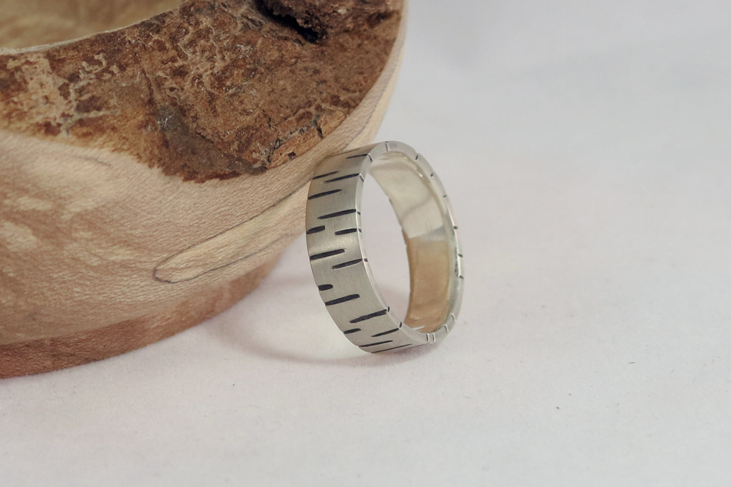 6mm sterling silver ring band with offset, randomly spaced, black lines.