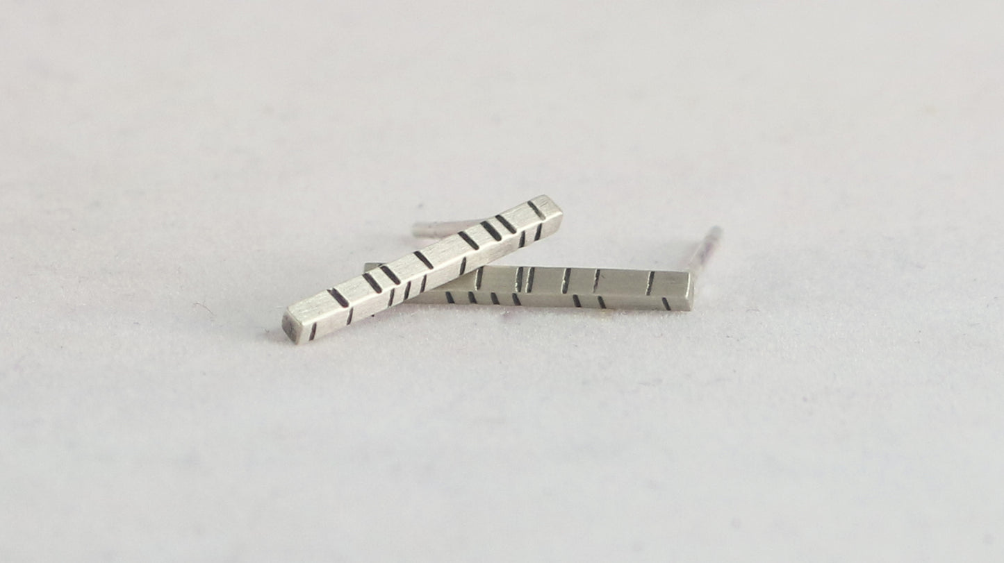 1.5mm thick solid sterling silver, rectangle bar studs with randomly spaced black lines.