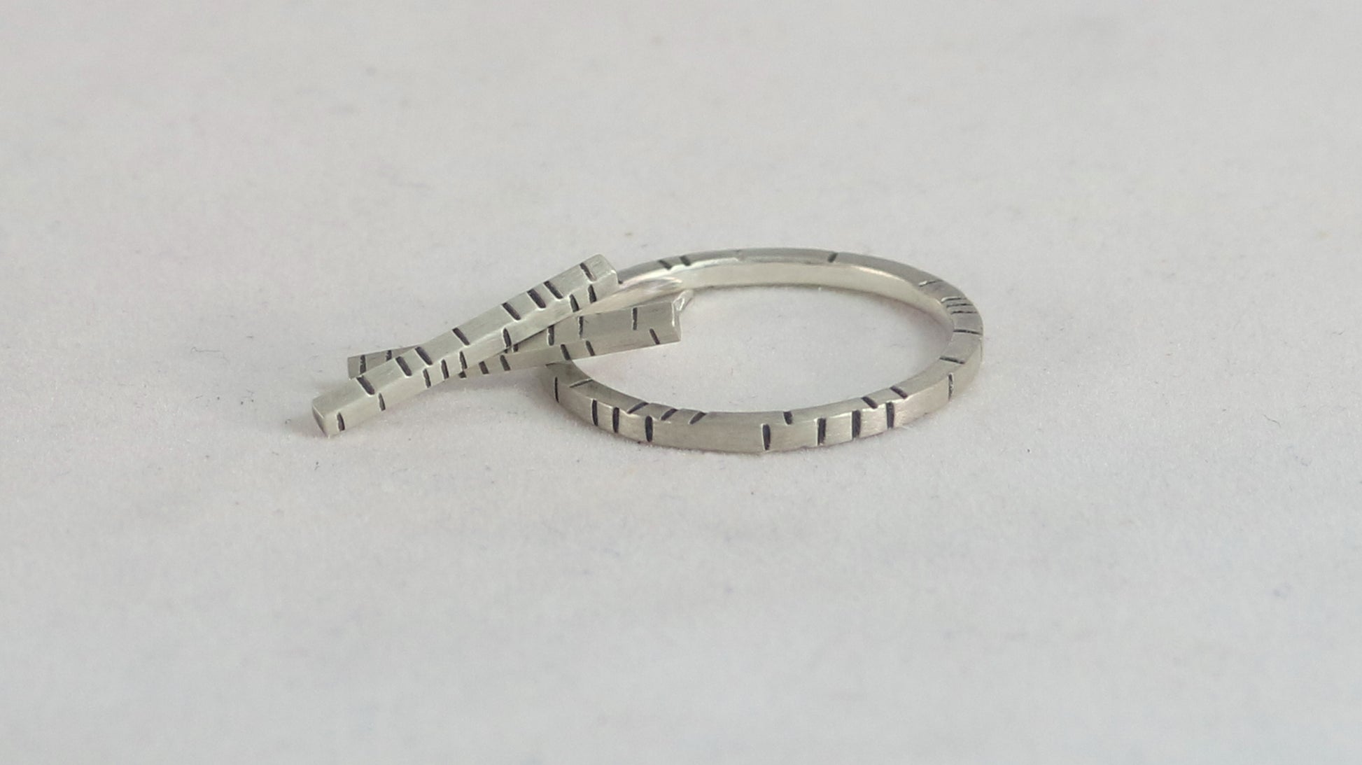 1.5mm thick solid sterling silver, rectangle bar studs with randomly spaced black lines.