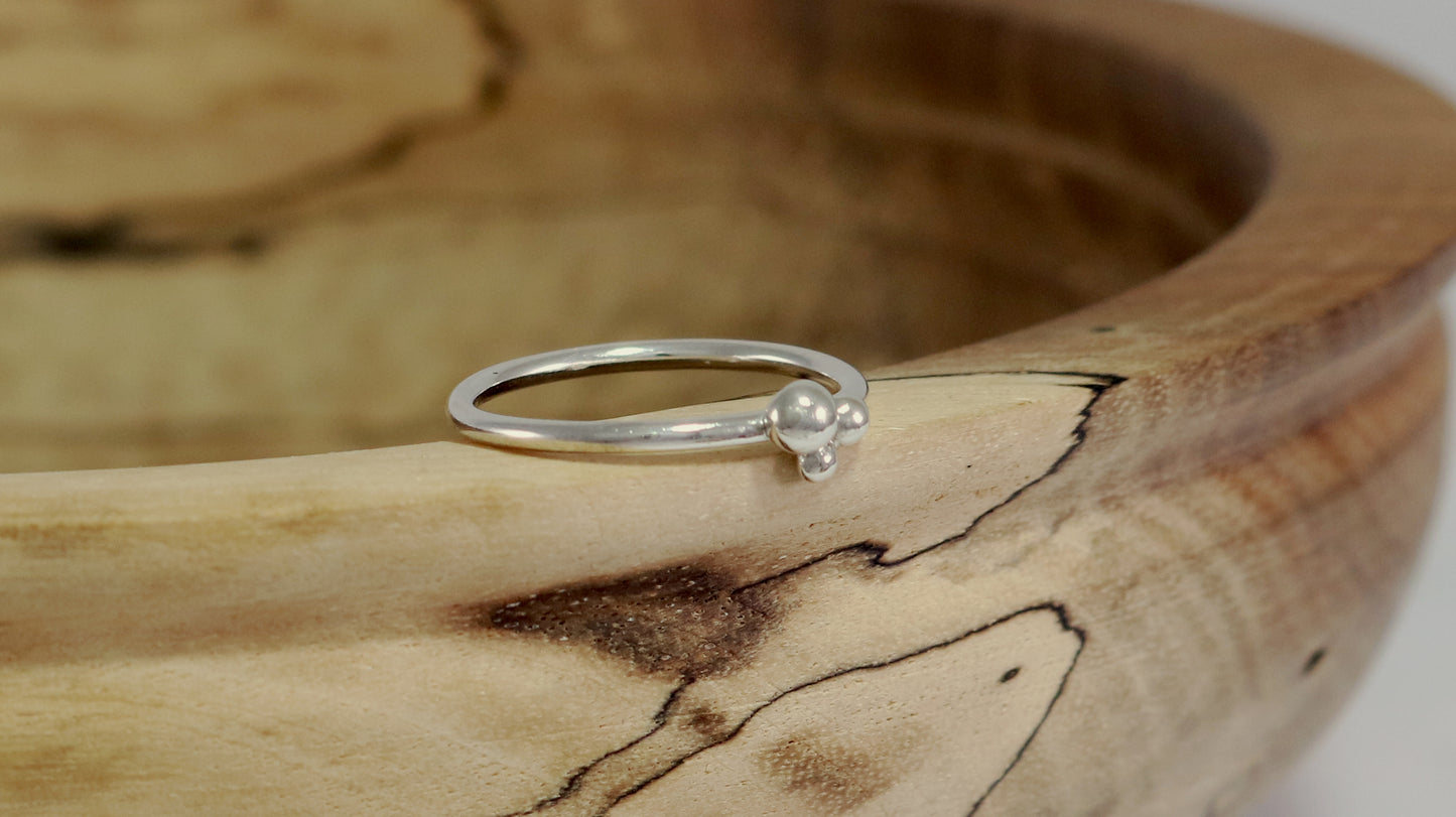 Three sterling silver bubbles in a pyramid on a sterling silver ring band.