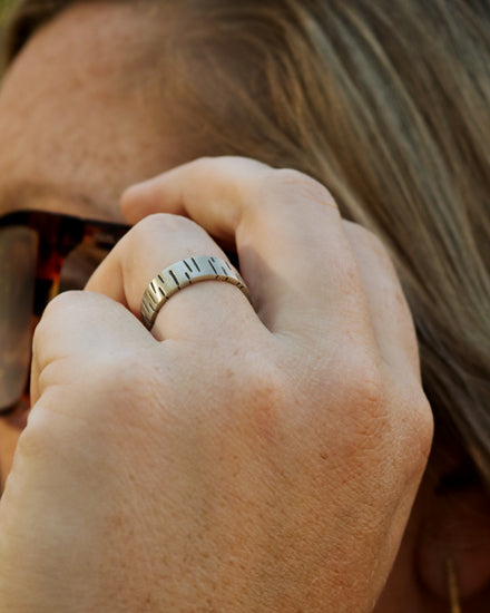 6mm sterling silver ring band with offset, randomly spaced, black lines.