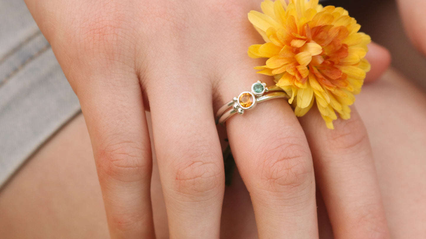 Natural gemstone set in sterling silver bezel, 3 silver bubble accents along bezel on sterling silver ring band.