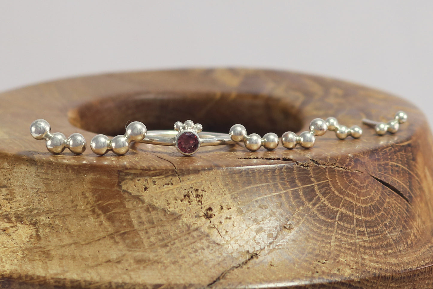 Sterling silver studs with three bubbles along a curve.